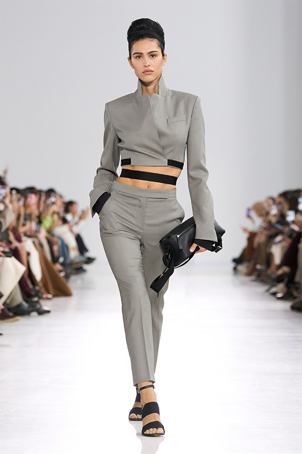 Max Mara Spring/Summer 2026 Fashion Show - Grey Suit Look with jacket and trousers with small black bag held in the hand.